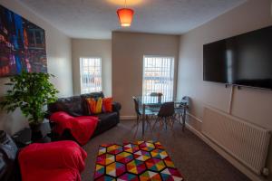 a living room with a couch and a table at Ample Comforts, Centrally Located, Town Centre in Warrington