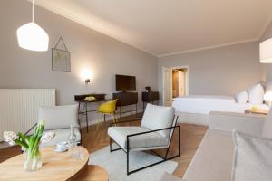 a hotel room with a bed and a table and chairs at Vju Hotel Rügen in Göhren