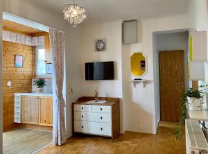 a living room with a dresser and a tv at Landhaus Klopein in Sankt Kanzian