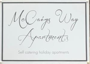 a sign that says new years way experiences self catering holiday appointments at McCaig's Way in Oban