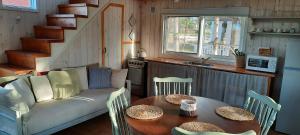 ein Wohnzimmer mit einem Sofa und einem Tisch in der Unterkunft Villa Alba in Punta Del Diablo