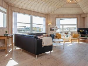 a living room with a couch and a table at 8 person holiday home in Harbo re in Harboør