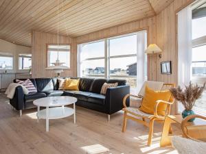a living room with a couch and a table at 8 person holiday home in Harbo re in Harboør