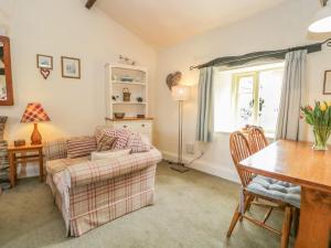 a living room with a couch and a table at Tyee Cottage in Carnforth