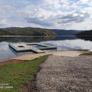 a dock on the side of a lake at PampiHouse in Pampilhosa da Serra