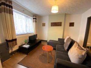 a living room with a couch and a table at Winstanley House in Wellingborough