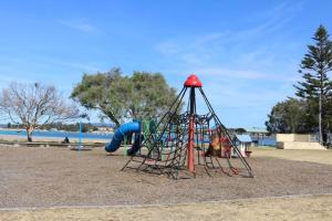 a playground with a slide in a park at ADS on Collins - 4 bedroom and Pet Friendly in Merimbula