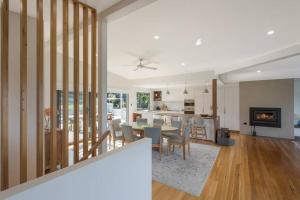 una cucina e un soggiorno con tavolo e sedie di ADS on Collins - 4 bedroom and Pet Friendly a Merimbula