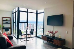a living room with a couch and a table at Amazing views SJO, Cozy, Equipped. 24/7 Concierge in San José