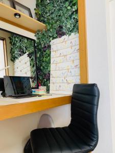 a chair in front of a desk with a green wall at COCO Nakameguro301 in Tokyo