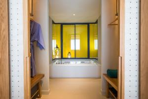 a bathroom with a bath tub and a window at KC Grande Resort Koh Chang in Ko Chang