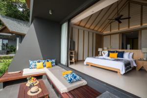 a master bedroom with a bed and a patio at KC Grande Resort Koh Chang in Ko Chang