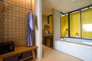 a bathroom with a bath tub and a window at KC Grande Resort Koh Chang in Ko Chang