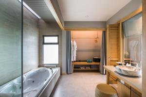 a bathroom with a tub and a sink at KC Grande Resort Koh Chang in Ko Chang