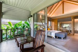 a bedroom with a bed and a balcony at KC Grande Resort Koh Chang in Ko Chang