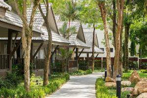 a walkway in front of a house with trees at KC Grande Resort Koh Chang in Ko Chang