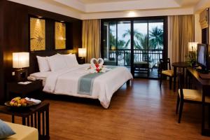 a hotel room with a bed with a flower on it at KC Grande Resort Koh Chang in Ko Chang