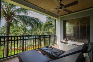 a room with a balcony with a tub and a sink at KC Grande Resort Koh Chang in Ko Chang