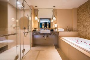 a bathroom with a tub and a sink and a shower at KC Grande Resort Koh Chang in Ko Chang
