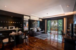 a living room with a couch and a table at KC Grande Resort Koh Chang in Ko Chang