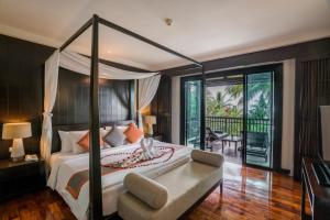 a bedroom with a large bed and a balcony at KC Grande Resort Koh Chang in Ko Chang
