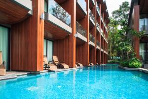 a swimming pool in front of a building at KC Grande Resort Koh Chang in Ko Chang