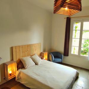 a bedroom with a large bed and a window at La Vigneronne des Costières in Vauvert +28 photos