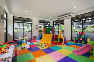a room with a play area with toys on the floor at KC Grande Resort Koh Chang in Ko Chang