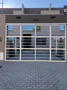 a building with a large garage door with windows at Duplex Charm in Salta