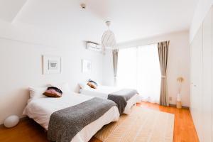 Postel nebo postele na pokoji v ubytování GuestHouse MIYABI