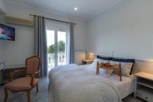 Ένα ή περισσότερα κρεβάτια σε δωμάτιο στο Villas Margaris