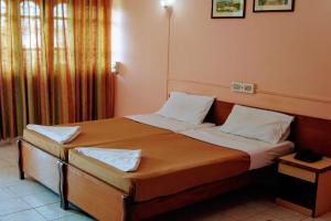 Postel nebo postele na pokoji v ubytování Vasco Residency