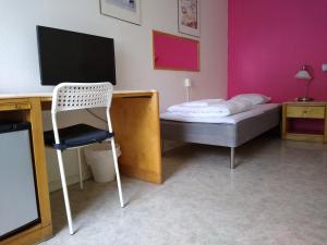 TV a/nebo společenská místnost v ubytování Hotell Milano