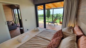 a bed in a room with a view of a patio at Collis winery - Family & Friends - Mobilhome in Rovinj