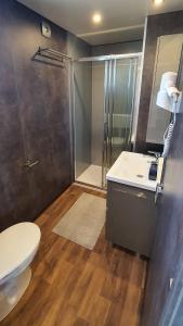a bathroom with a shower and a toilet and a sink at Collis winery - Family & Friends - Mobilhome in Rovinj
