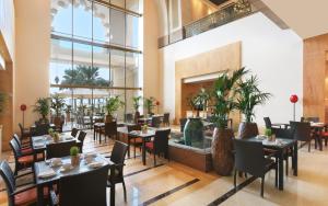 
a dining room with tables, chairs, and tables in it at Fairmont The Palm in Dubai
