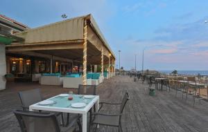 a restaurant with tables and chairs on the beach at Calangute Residency in Calangute