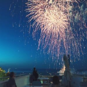 a firework display in the sky over the ocean at B&B Alalama in Polignano a Mare