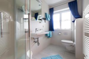a bathroom with a sink and a toilet at Gästehaus Walpurga in Russbach am Pass Gschütt +50 photos