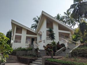 a house with stairs in front of it at Farmagudi Residency in Ponda
