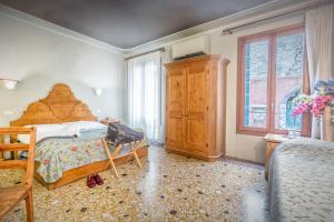 Postel nebo postele na pokoji v ubytování Alloggi B&b Allegri