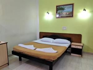 a bedroom with two beds with towels on them at Farmagudi Residency in Ponda