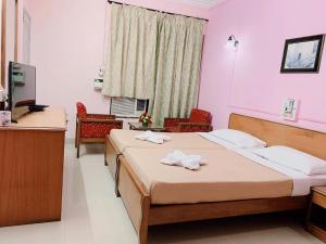 Ένα ή περισσότερα κρεβάτια σε δωμάτιο στο Margao Residency