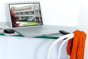 a laptop computer sitting on top of a desk at Premiere Classe Epinal in Épinal