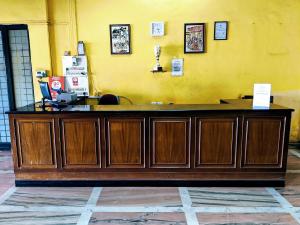 a large wooden counter in front of a yellow wall at Mapusa Residency in Mapusa