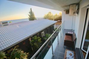 a balcony of a house with a view of the ocean at SeaView 1BR balcony Apartment in Sochi