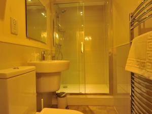 a bathroom with a shower and a toilet and a sink at Gail's Guest House in Barry