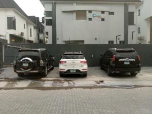 two cars parked in a parking lot with a hose at Ocean Park Hotel,Lekki phase 1 in Lekki