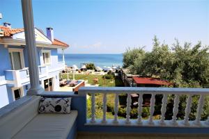 a balcony with a view of the ocean at Cundavilla Hotel & Suites in Ayvalık