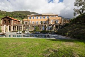 a house with a bridge over a river at Mirandola Suites in Arenzano